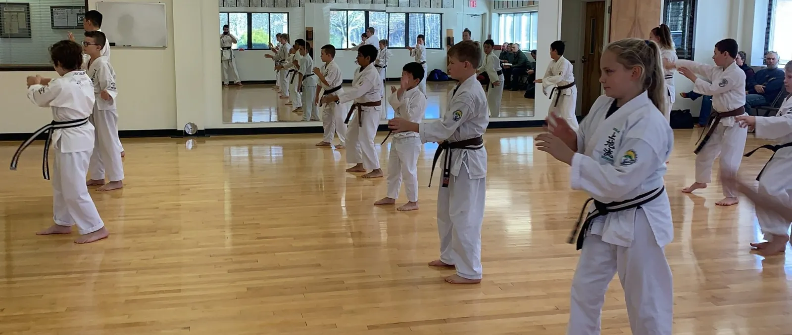 Junior karate students training together in a dojo