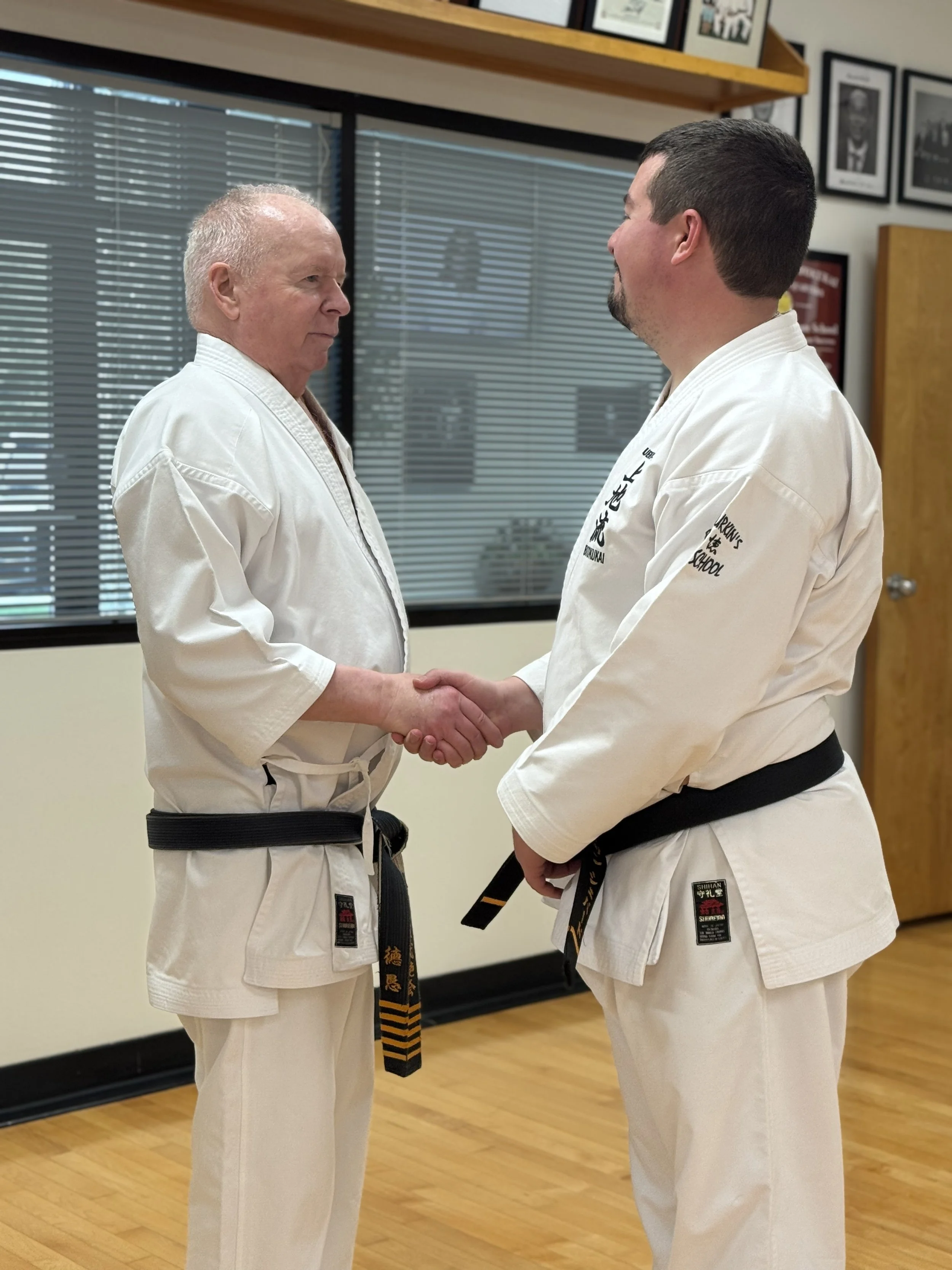 Jonathan Shepard shaking hands with Buzz Durkin at the dojo