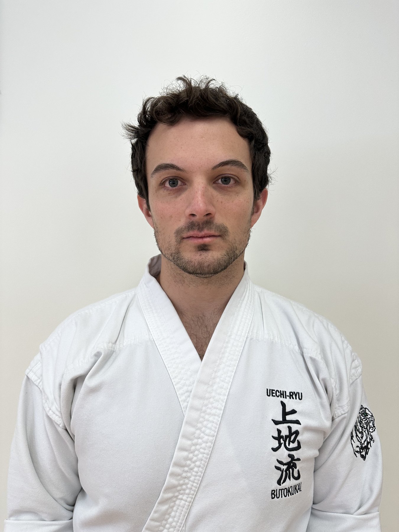 Tyler Rose facing the camera in a karate uniform